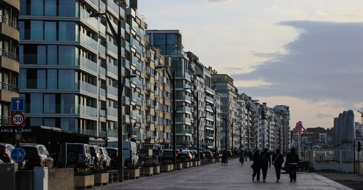 Seaside promenade with modern architecture in Knokke-Heist, Flanders, Belgium during dusk.
