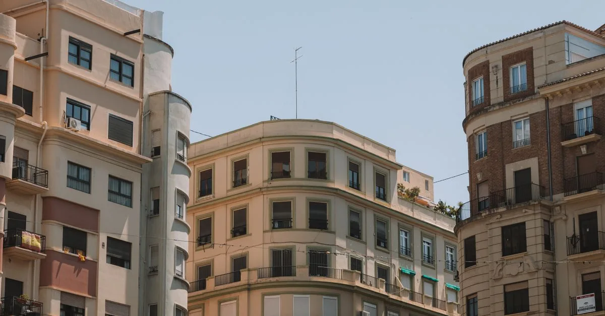 Explore the traditional architecture and sunny facades of Valencia's charming apartment buildings.