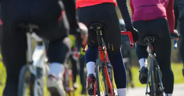 Group of cyclists riding on a sunny day, showcasing endurance and teamwork in outdoor sports.