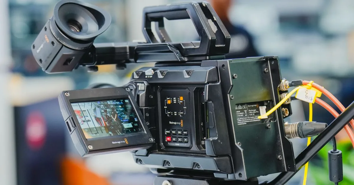 Close-up of a professional video camera setup in an indoor studio environment.