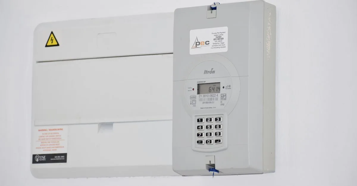Electrical meter and fuse box on a white wall in Cape Town, South Africa, for energy monitoring or billing.