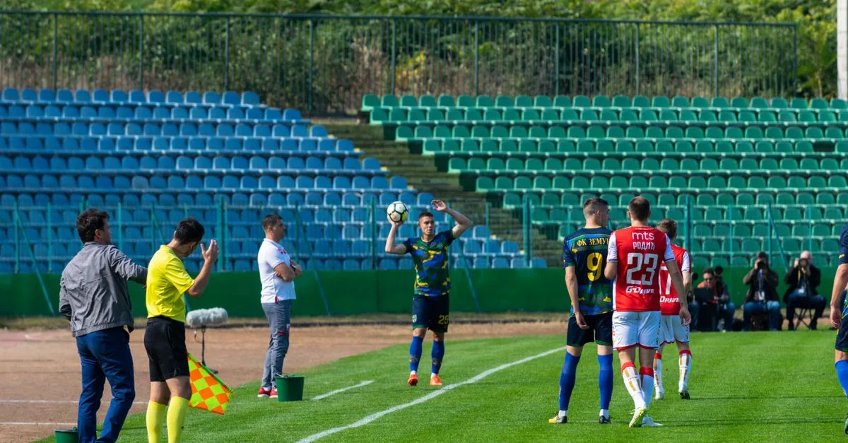 Soccer players in action during a lively match at an outdoor stadium.