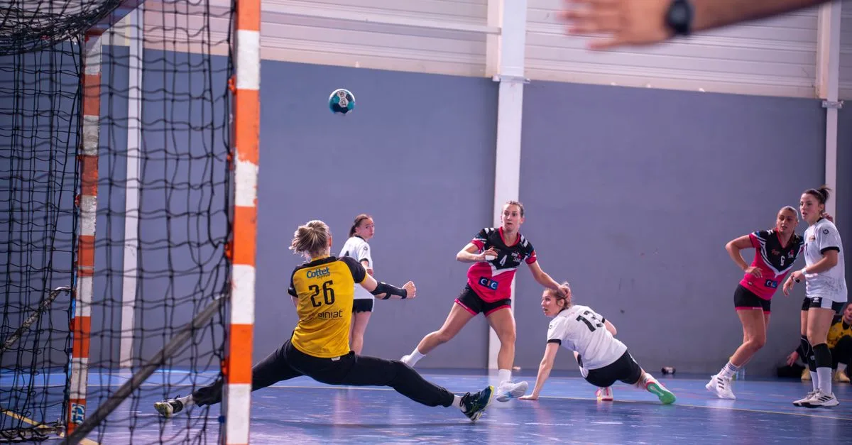 Dynamic action shot of a women's handball match with players in mid-movement.