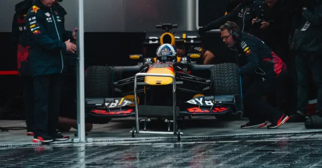 Red Bull Racing pit crew readying the Formula 1 car during an intense race event.
