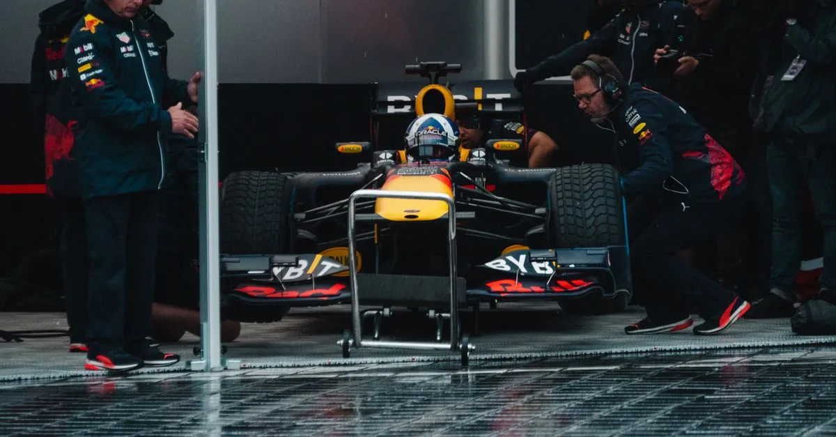 Red Bull Racing pit crew readying the Formula 1 car during an intense race event.