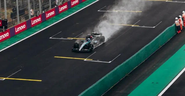 Formula 1 car speeding on wet track during race. High-energy motorsport action.