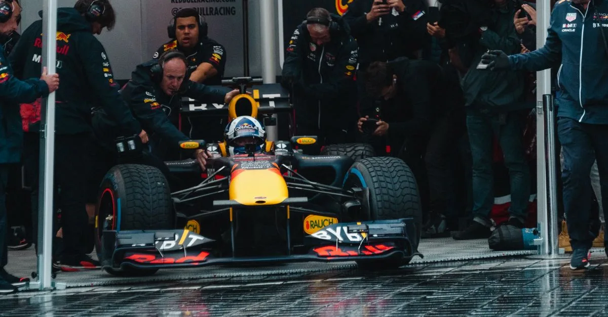 Exciting Formula One car during a dynamic pit stop, showcasing teamwork and precision.