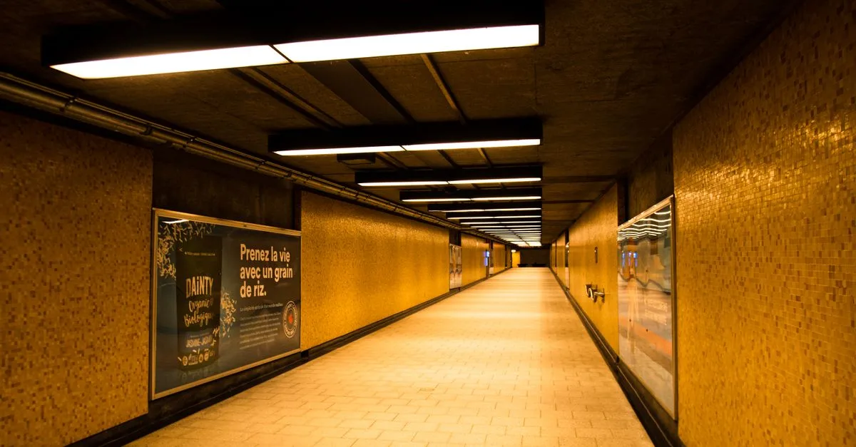 A warm lit underground metro tunnel with yellow tiles in Montreal, Canada, creating a moody atmosphere.