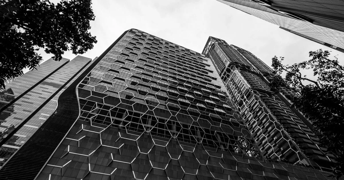 Dynamic black and white view of skyscrapers with modern architecture.