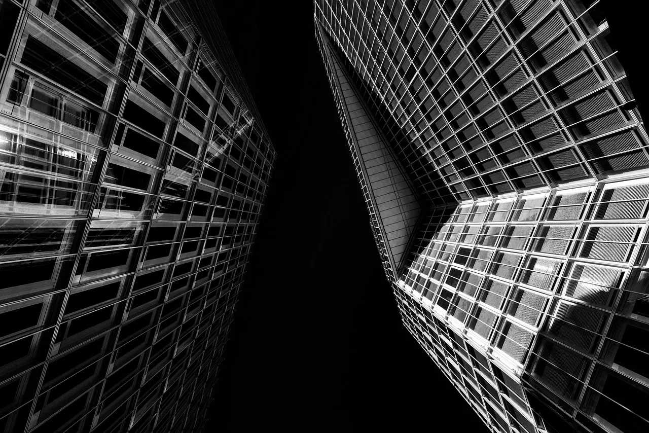 A modern glass office building exterior representing global finance and corporate expansion.
