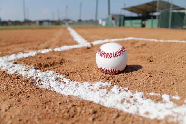 An empty professional baseball stadium field under clear skies.