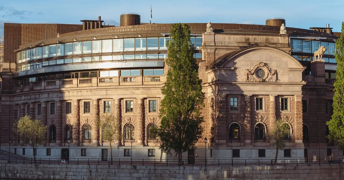 Swedish Parliament House by the waterfront with warm sunset lighting in Stockholm.