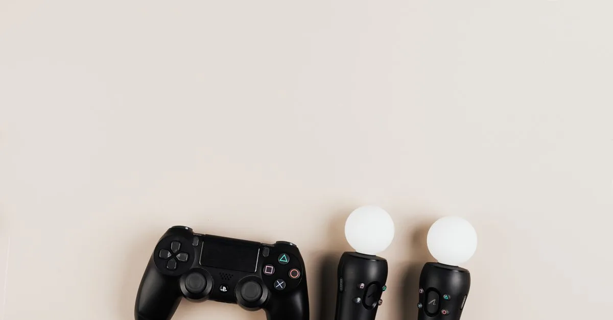 Black gaming controllers arranged on a light background with ample copy space.