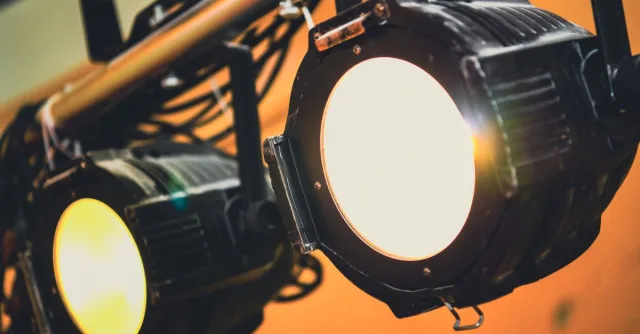 Detailed view of illuminated stage spotlights casting soft warm light