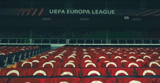 Rows of empty stadium seats adorned with UEFA Europa League banners, creating a sporting event atmosphere.