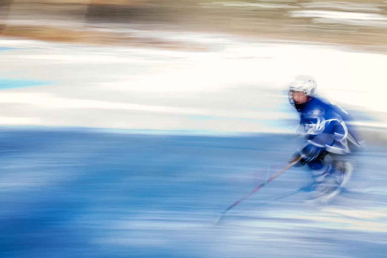 A professional ice hockey player skating on the rink during a competitive game.