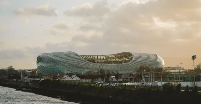 View of Dublin's Aviva Stadium with dramatic clouds during sunset.