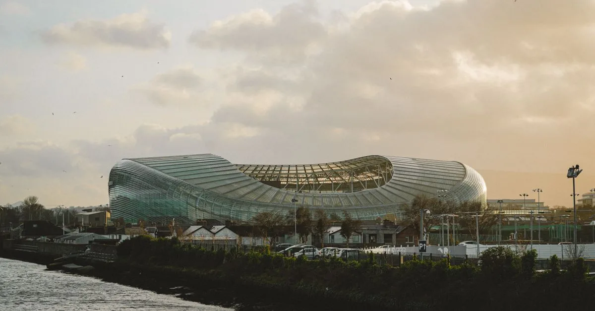 View of Dublin's Aviva Stadium with dramatic clouds during sunset.