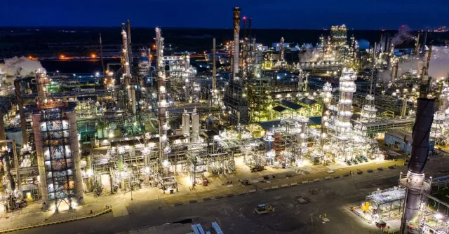 Dramatic aerial shot of an illuminated oil refinery at night in Rosemount, MN.