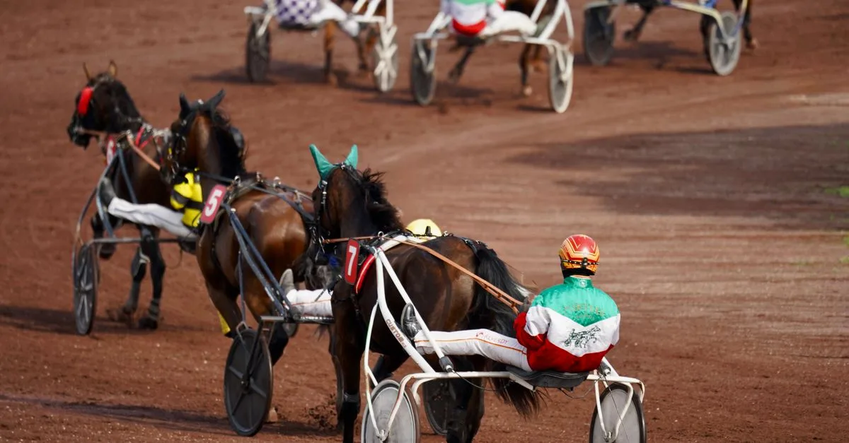 Harness racing action on a dirt track featuring drivers in colorful silks.
