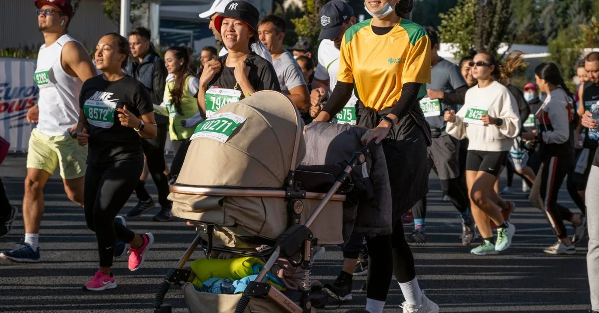 Group of diverse marathon runners in athletic gear participating in an outdoor race with positive energy.