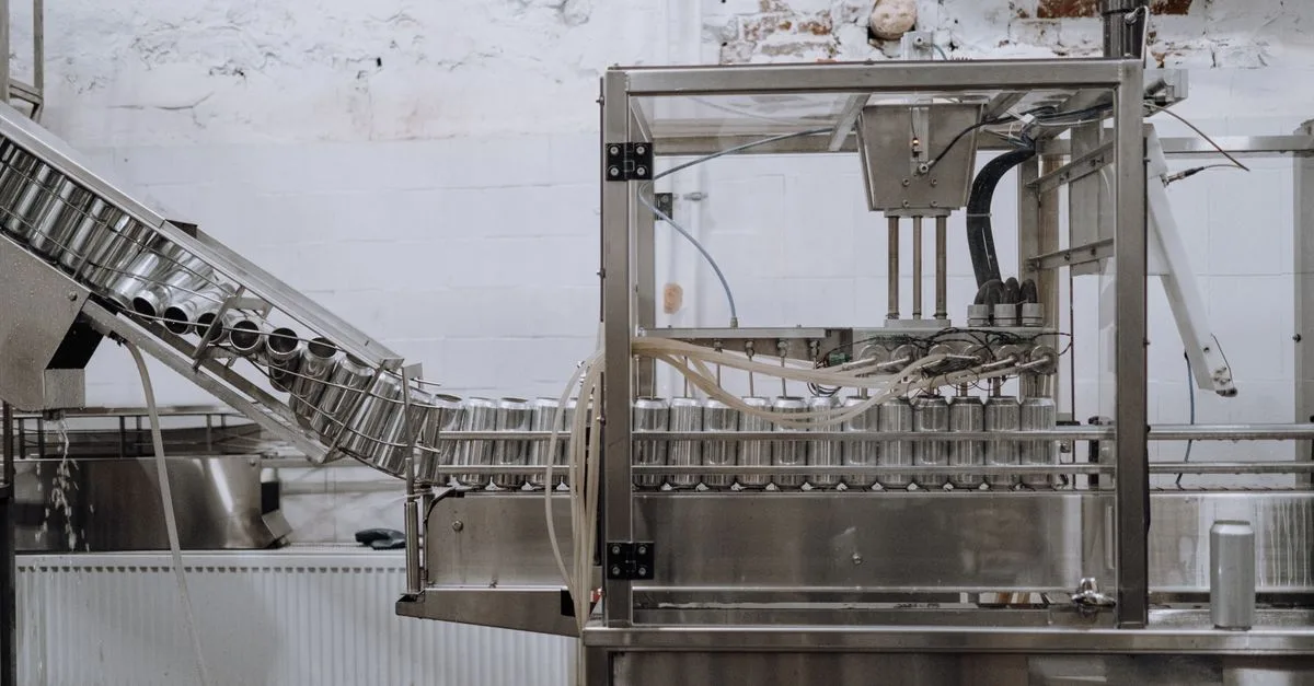 Automated beverage can packaging in a modern factory setting.