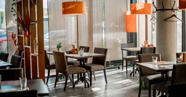 Cozy restaurant interior featuring elegant decor and warm lighting.