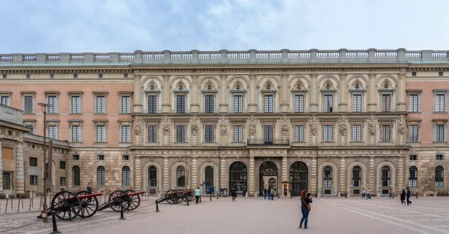 A wide-angle view of Stockholm Royal Palace showcasing its stunning Baroque architecture and open courtyard.