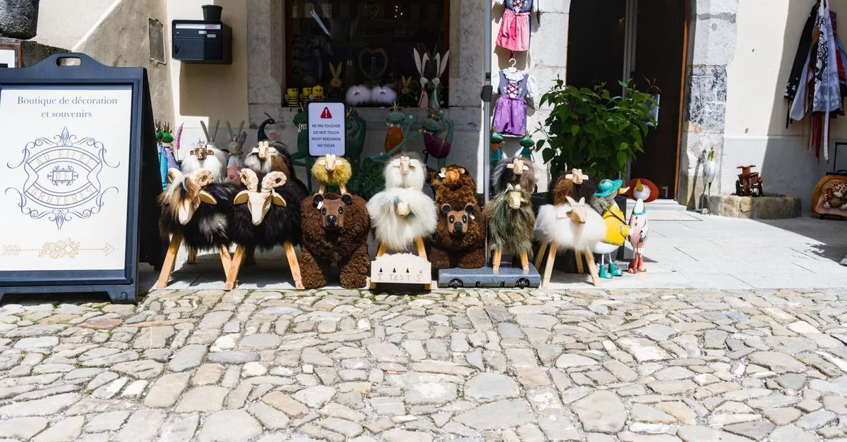 A delightful shop display featuring plush toys at a Gruyères souvenir store entrance.