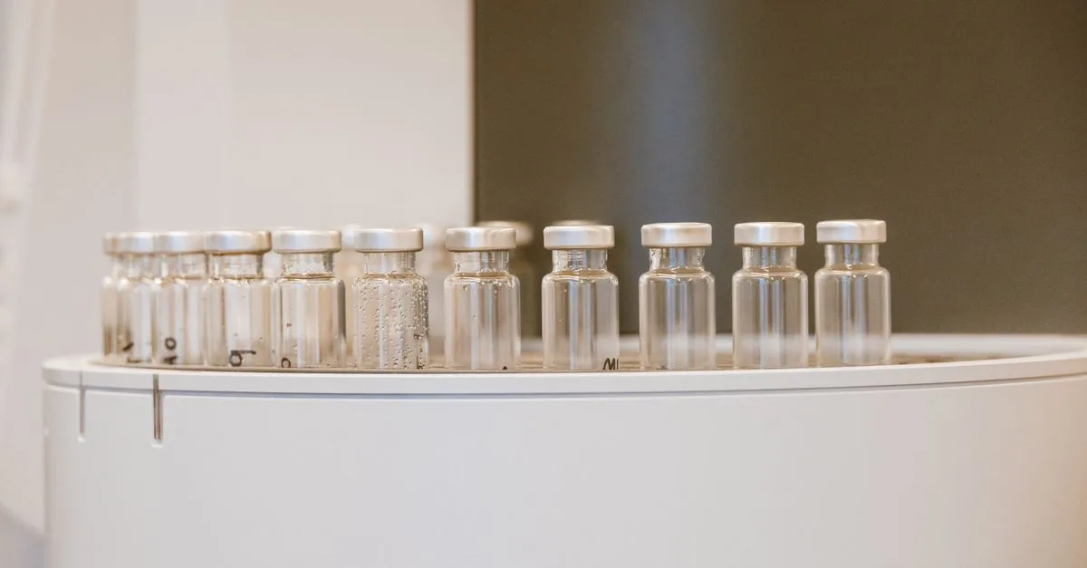Close-up of empty glass vials arranged in a laboratory environment.