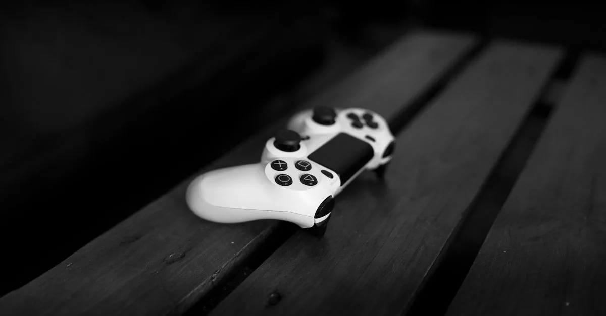 Black and white photo of a gaming controller on a wooden table, perfect for gaming or tech themes.