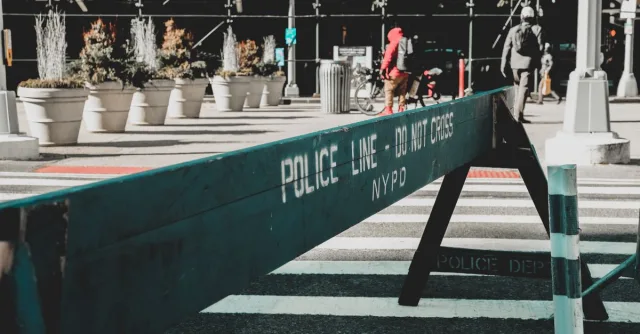 Close-up of NYPD police barrier in city street setting highlighting urban safety measures.