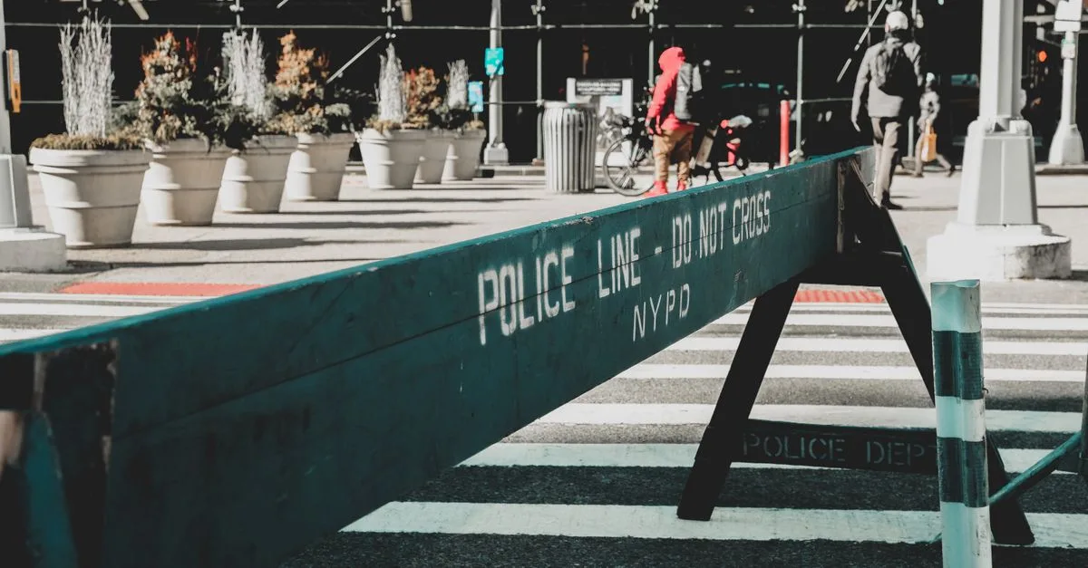 Close-up of NYPD police barrier in city street setting highlighting urban safety measures.