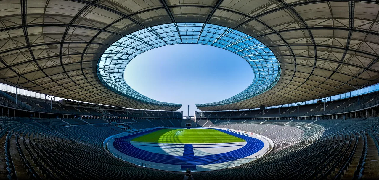 A professional football stadium lit up at night during a match.