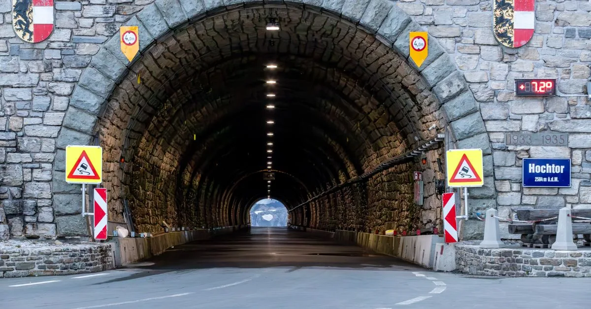 Captivating view of the Hochtor Tunnel entrance in Kärnten, Austria, framed by alpine stonework.