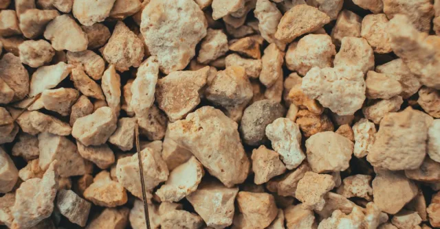 Detailed close-up of brown gravel and stones, showcasing texture and variety.