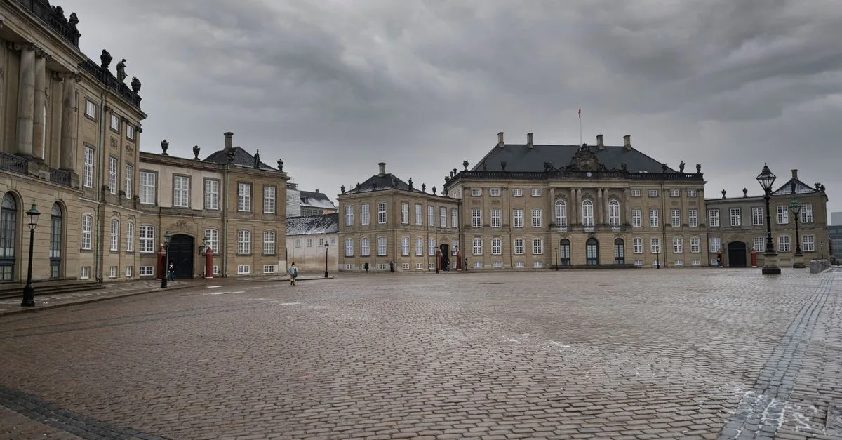 A view of the historic Amalienborg Palace in Copenhagen with overcast skies.