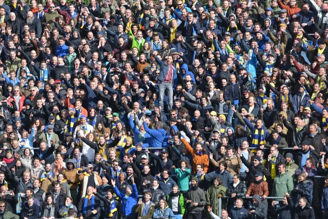A wide shot of a professional football stadium during a match.
