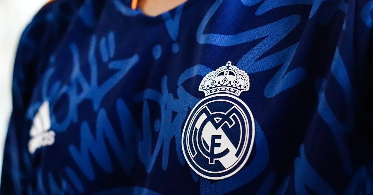 Detailed view of a blue soccer jersey featuring a prominent club emblem, ideal for sports branding.