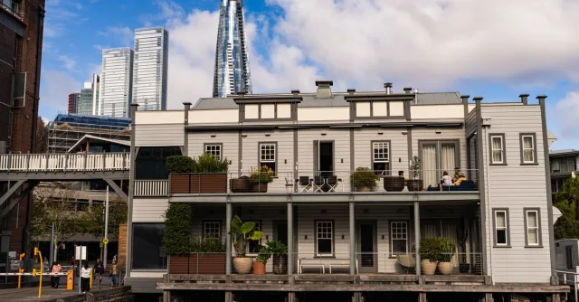 Historic waterfront building with modern skyscrapers in background, Sydney, Australia