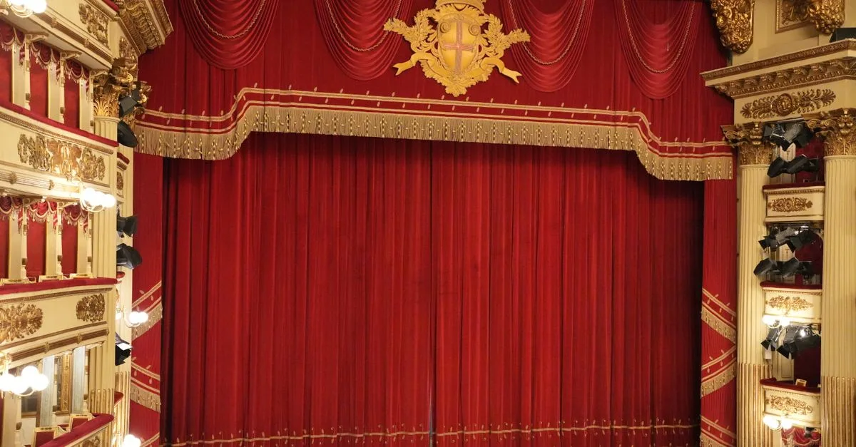 Stunning red curtain inside an ornate Italian opera house, showcasing opulent architecture and classic theater design.