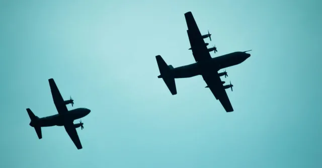 Silhouetted airplanes flying in formation against a clear sky in Mexico City.
