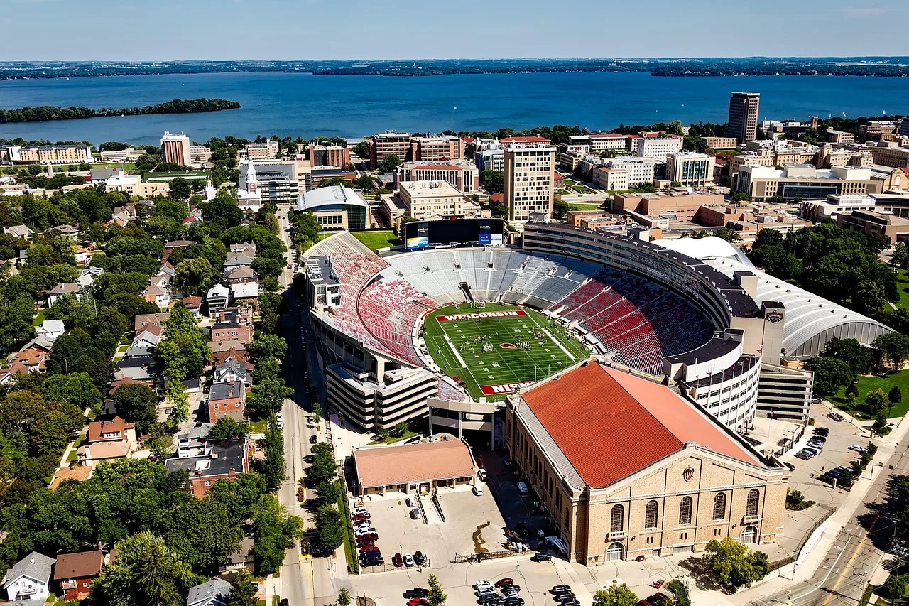 A wide shot of a college football stadium field before a game.