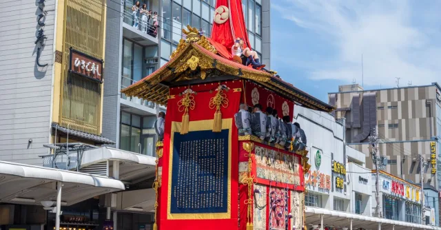 Traditional float parading in Kyoto's Gion Matsuri festival, cultural celebration outdoors.