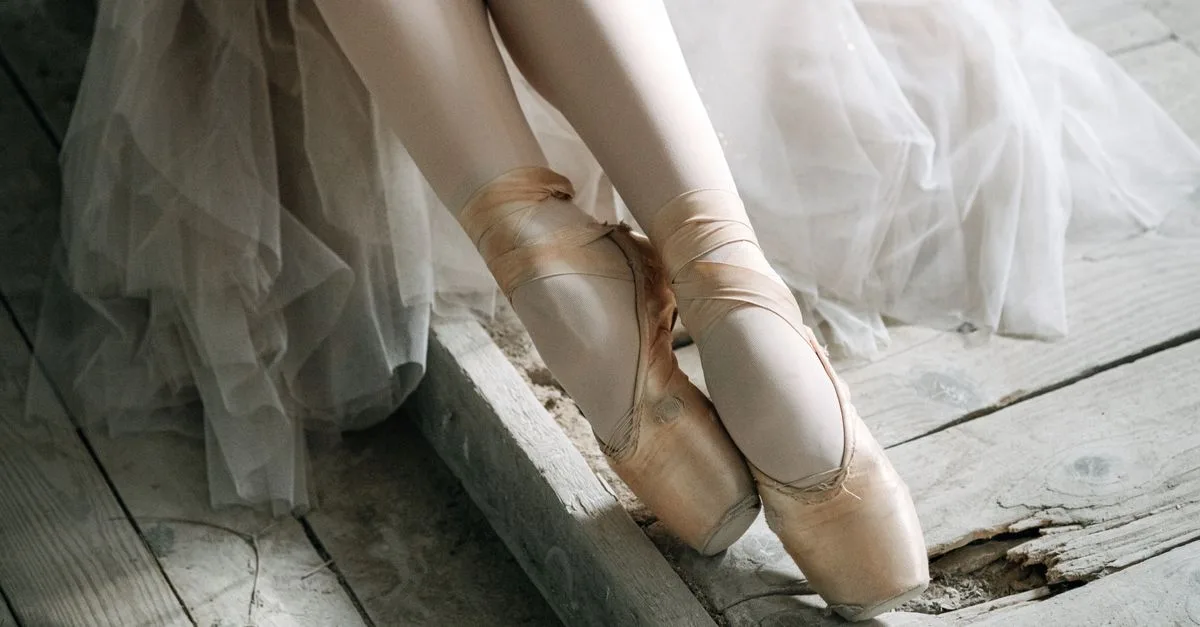 Graceful ballerina in pointe shoes captured in a serene and delicate setting, highlighting elegance.
