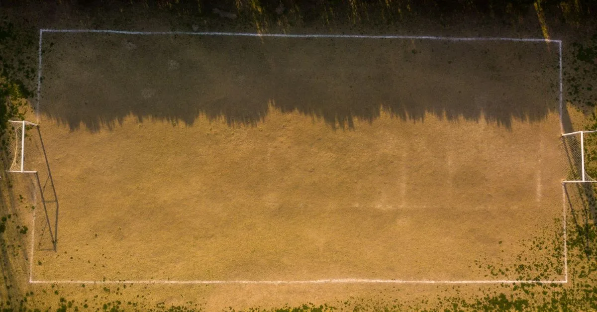 Drone shot of an empty soccer field in Buenos Aires showing light and shadow play.