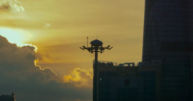 Beautiful sunset over Ho Chi Minh City skyline featuring Bitexco Tower and dramatic clouds.
