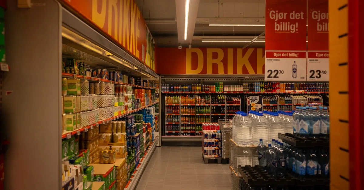 Colorful drink aisle in a supermarket with signage promoting deals.