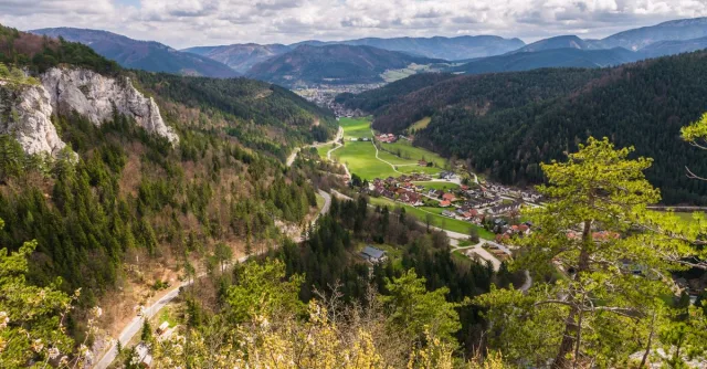 A breathtaking aerial view of a picturesque village nestled in a lush mountain valley.