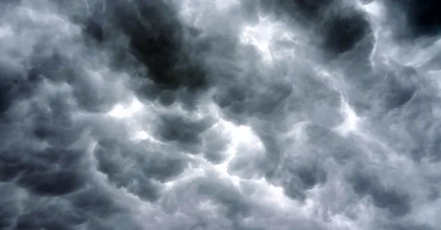 Majestic storm clouds fill the sky, creating a dramatic, moody atmosphere.